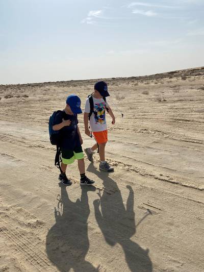 Finlay and his brother Frankie walk in the desert.