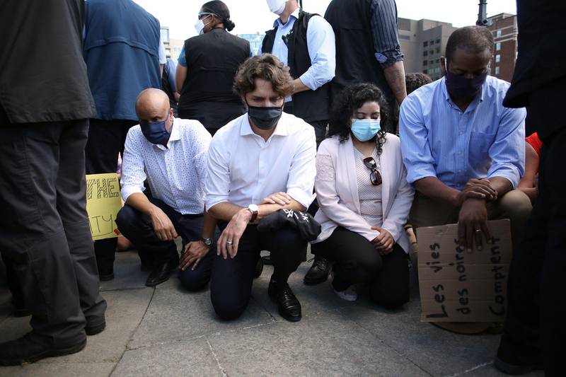 Canadian Prime Minister Justin Trudeau, second left, takes a knee during in a Black Lives Matter protest on Parliament Hill, Ottawa, Canada. AFP