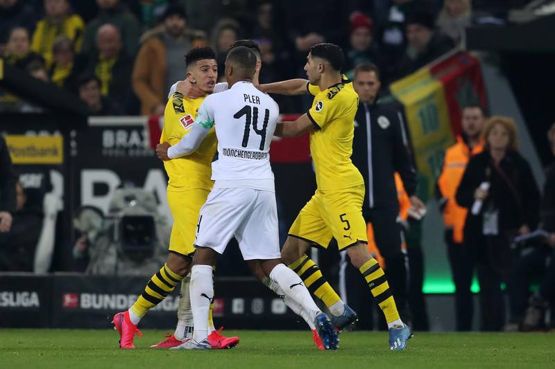 Jadon Sancho gets to grips with Alassane Plea of Borussia Moenchengladbach in their Bundesliga match in March. Getty