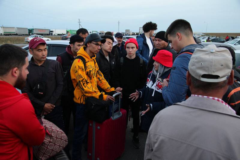 Russians are helped by a volunteer upon arrival in Kazakhstan last week. AFP