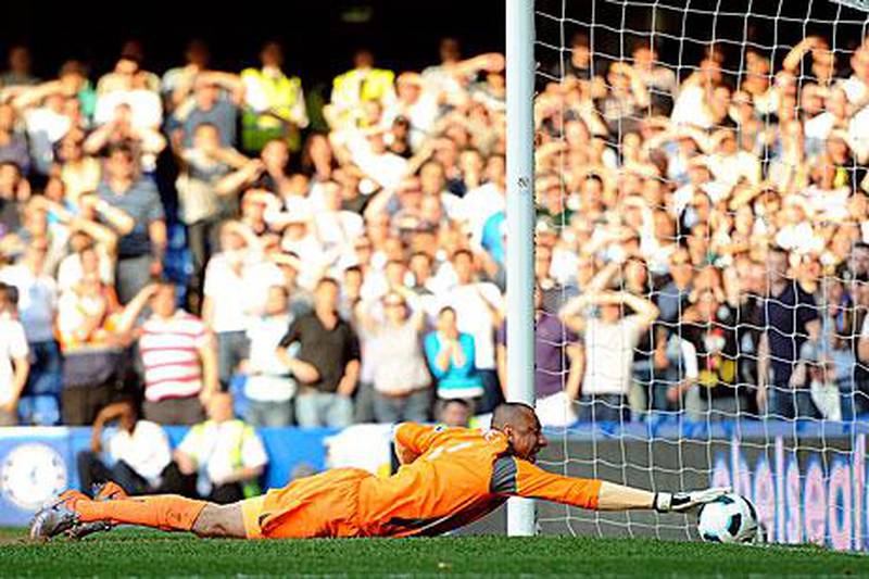 Tottenham Hotspur's goalkeeper Heurelho Gomes attempts to prevent Chelsea's Frank Lampard's shot from crossing the line.