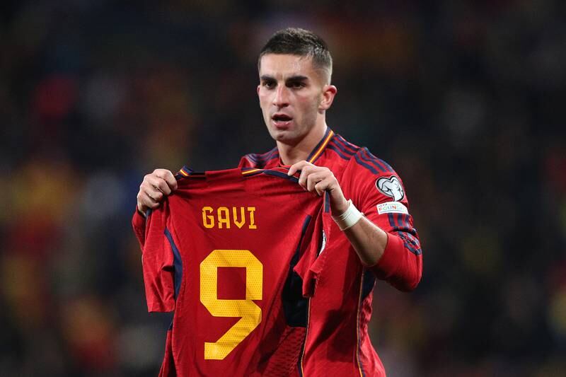 Ferran Torres holds up the shirt of teammate Gavi after scoring for Spain. Getty Images
