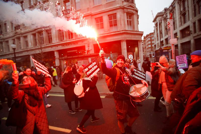 A marcher burns a flare during the NHS staff protest in London. Reuters