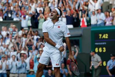 Switzerland's Roger Federer celebrates after beating Spain's Rafael Nadal in a Men's singles semifinal match on day eleven of the Wimbledon Tennis Championships in London, Friday, July 12, 2019. (Adrian Dennis/Pool Photo via AP)