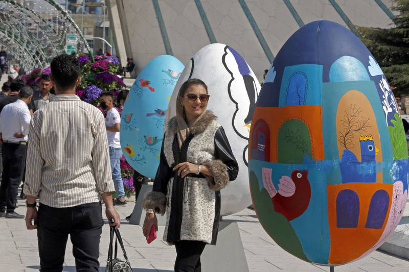 People gather around colourful eggs in Tehran's Azadi Square on Monday as they celebrate Nowruz. AFP