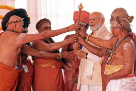 India's Prime Minister Narendra Modi holds the Sengol, a Tamil sceptre, along with priests during the inauguration ceremony of the country's new parliament building in New Delhi on Sunday. AFP