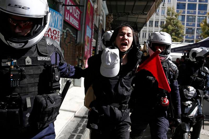 Riot policemen detain a protester in Athens. EPA