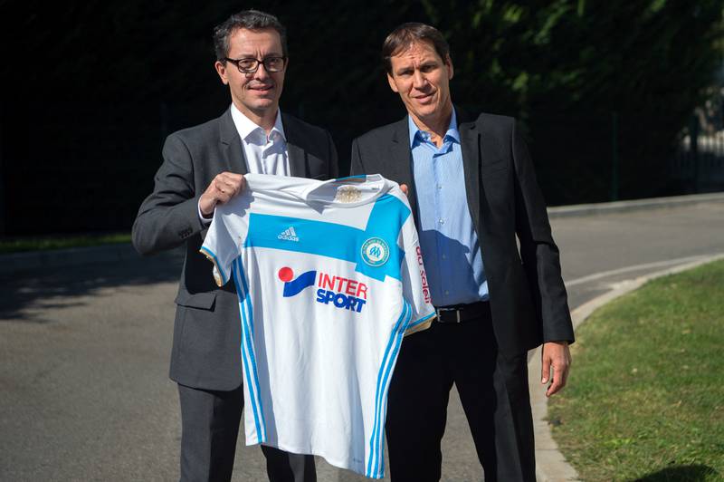 Rudi Garcia and Olympique de Marseille French President Jacques-Henri Eyraud pose with a team jersey as they arrive to take part in a press conference at the club's training centre in Marseille, southern France, on October 21, 2016. AFP
