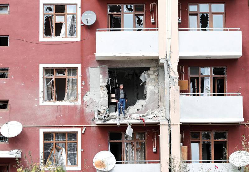 A man looks out from his damaged home after a ceasefire begins during the fighting over the breakaway region of Nagorno-Karabakh in the city of Terter, Azerbaijan.  Reuters