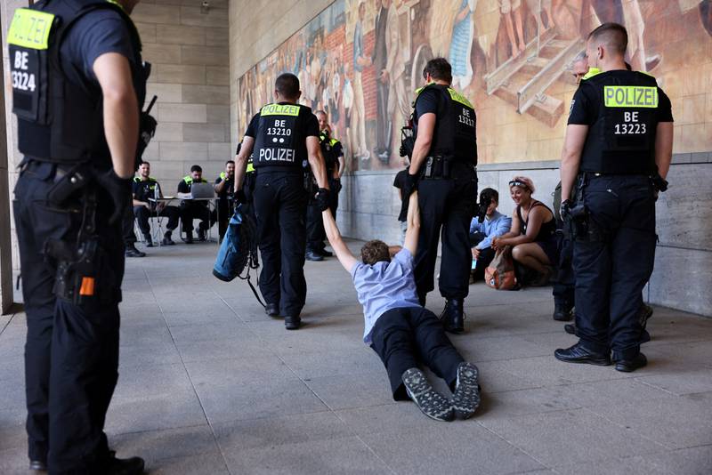Police officers remove an activist during a demonstration blocking the German Ministry of Finance, while the G7 summit takes place in Elmau, Germany. Reuters