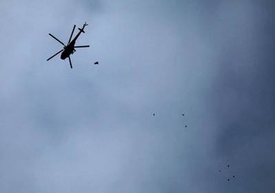 A Russian-made Syrian army attack helicopter dropping a payload over the rebel-held town of Arbin, in the besieged Eastern Ghouta region. Amer Almohibany / AFP