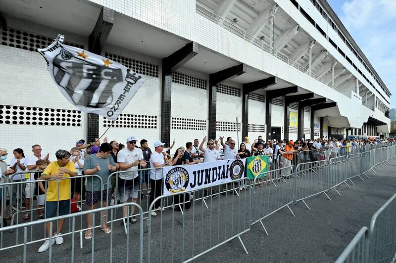 Mourners queue outside the Urbano Caldeira Stadium ahead of Pele's wake ceremony. Getty