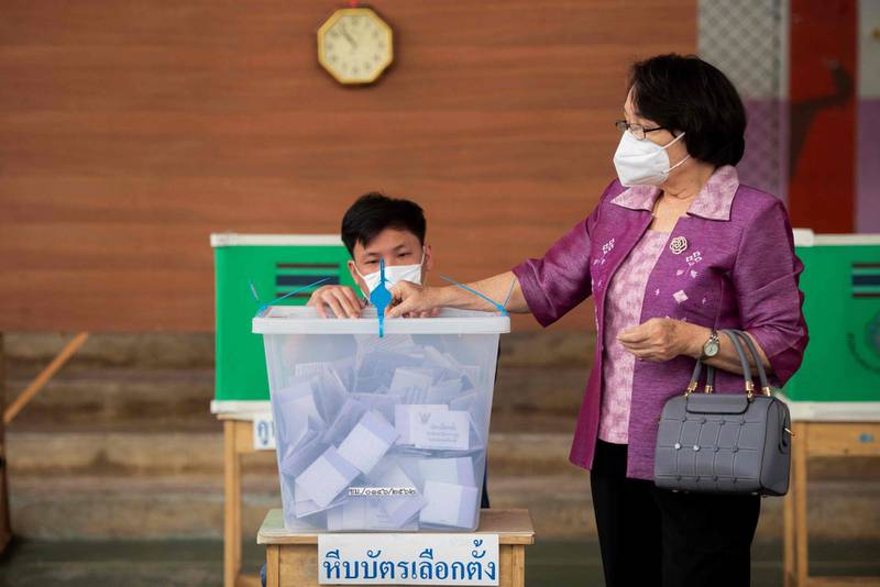 A woman casts her ballot at a polling station in Chiang Mai. AFP