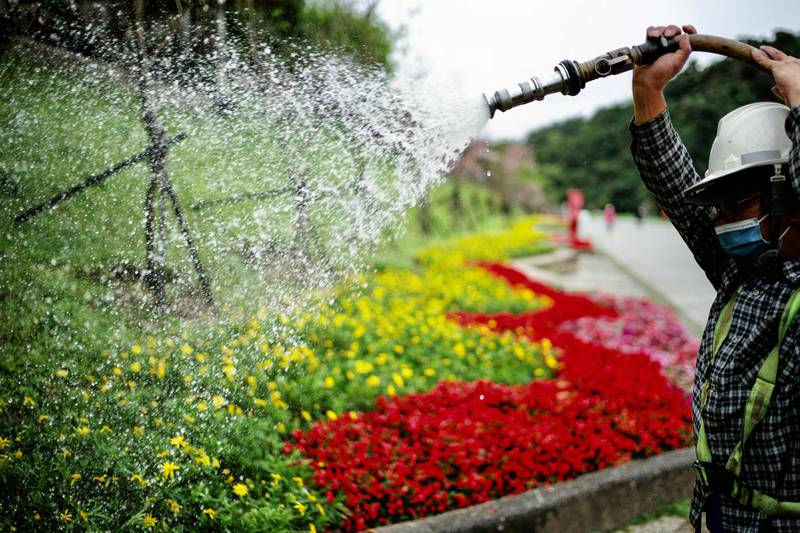 Flowers are watered in Bitan, a tourist hot spot in New Taipei City, Taiwan. AFP