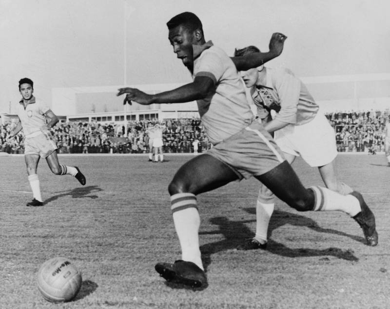 Pele dribbles past a defender during a friendly match between Malmo and Brazil, on May 8 1960, in Malmo. Pele scored two goals as Brazil won 7-1. AFP