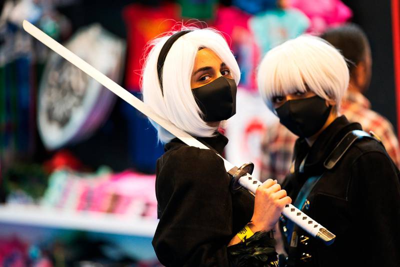 Two women dressed as sword-wielding anime characters pose for a photograph at the Middle East Film & Comic Con in Dubai. AP Photo
