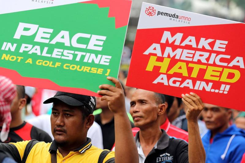 Malaysians hold placards during a demonstration against, outside the US embassy in Kuala Lumpur on December 8, 2017. AFP