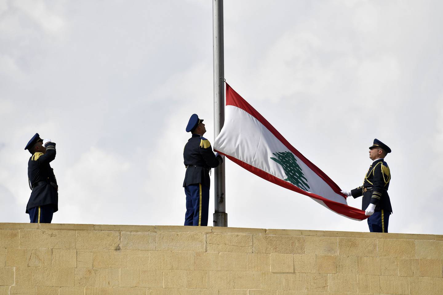 Members of the presidential guards remove a Lebanese flag after six-year term of former Lebanese President Michel Aoun officially ended, at Baabda Palace, east of Beirut, Lebanon, on November 01. EPA