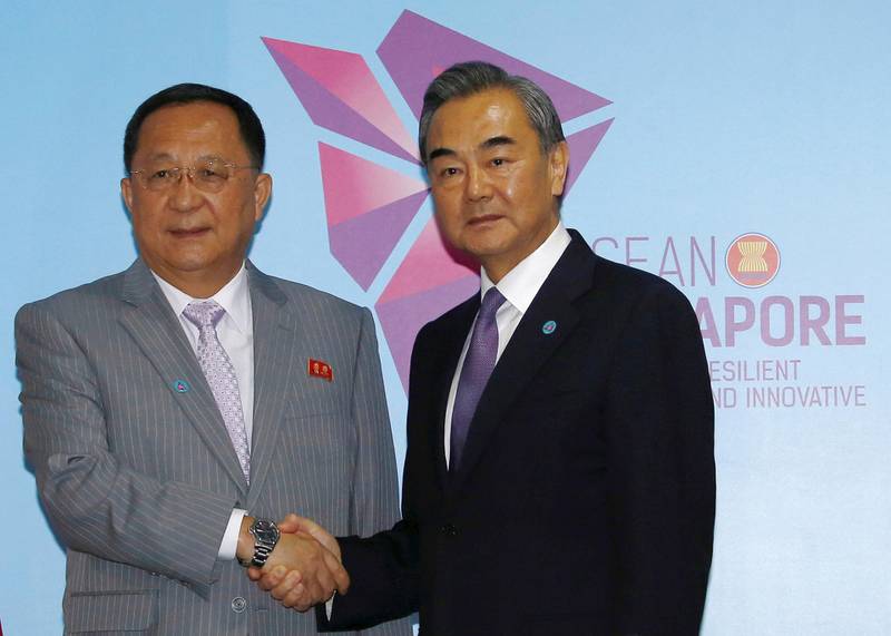 North Korea's Foreign Minister Ri Yong Ho and China's Foreign Minister Wang Yi shake hands at a bilateral meeting on the sidelines of the ASEAN Foreign Ministers' Meeting in Singapore, August 3, 2018. REUTERS/Feline Lim