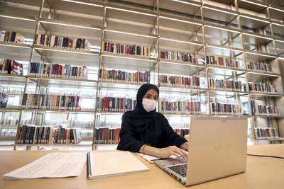 Sharjah, United Arab Emirates - December 10, 2020: News. Arts. Sara works on her laptop. Opening of the House of Wisdom, a high tech new library. Thursday, December 10th, 2020 in Sharjah. Chris Whiteoak / The National