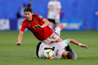 Spain's Lucia Garcia in action with Germany's Alexandra Popp. Reuters