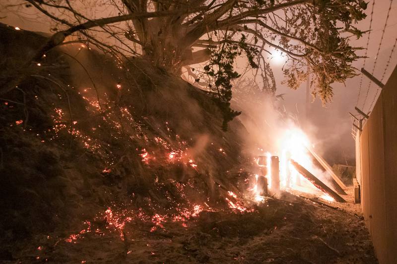 A wildfire known as the Colorado Fire engulfs fencing next to Highway 1, near Big Sur, California, US. All photos: AP Photo