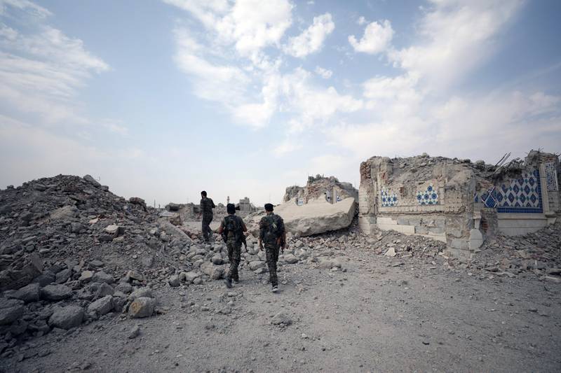Fighters from Syrian Democratic Forces (SDF) stand near destroyed Uwais al-Qarni shrine in Raqqa, Syria September 16, 2017. REUTERS/Rodi Said
