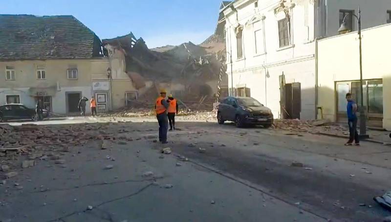 A grab of a video taken and released by the Croatian Red Cross on shows people looking through the rubbles and rescuing victims in the streets of Petrinja, after the town was striked by an earthquake of 6,4 magnitude.  AFP