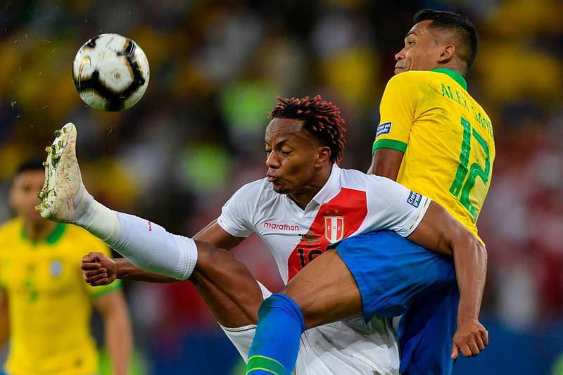 Peru's Andre Carrillo and Brazil's Alex Sandro vie for the ball. AFP