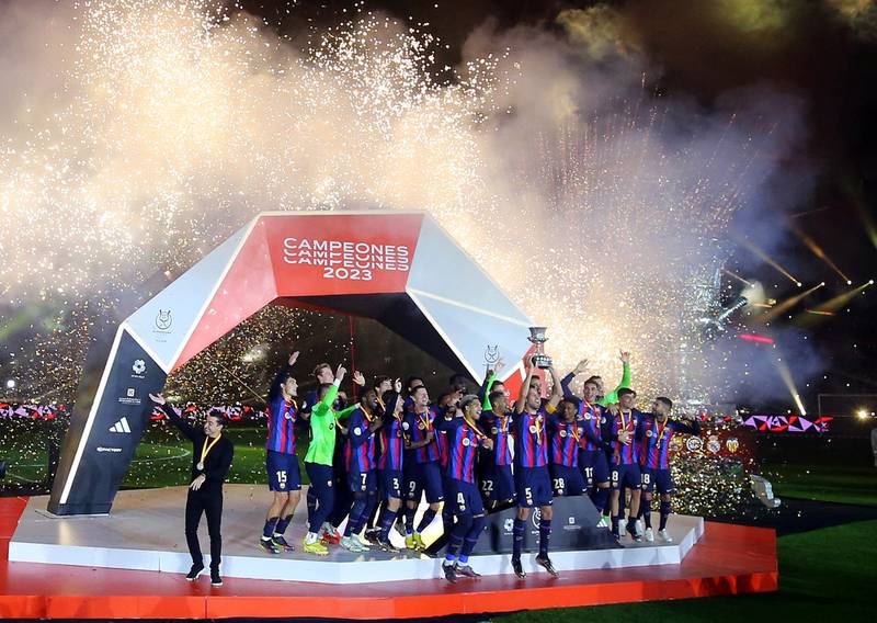 Barcelona's Sergio Busquets lifts the trophy after winning the Spanish Super Cup in Riyadh. Reuters