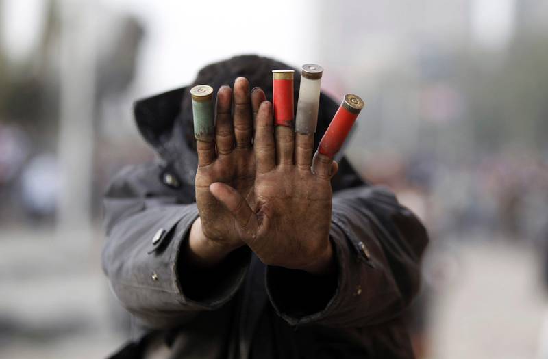 A protester against Egypt's President Mohamed Mursi shows expended shotgun cartridges that he said was fired by riot police during clashes along Qasr Al Nil bridge, which leads to Tahrir Square in Cairo January 27, 2013. Egyptian President Mohamed Mursi announced on Sunday he was imposing a state of emergency for 30 days in three cities along the Suez Canal that have been the scene of the worst violence that flared at the weekend, killing more than 45 people. REUTERS/Amr Abdallah Dalsh (EGYPT - Tags: POLITICS CIVIL UNREST TPX IMAGES OF THE DAY) *** Local Caption ***  AMR014_EGYPT-PROTES_0127_11.JPG
