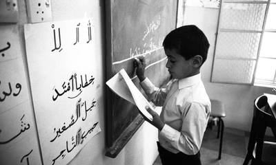 Sheikh Mohamed practises writing in March 1969. He was schooled in Al Ain, Abu Dhabi, Rabat in Morocco and spent a summer at Gordonstoun in Scotland. Photo: National Archives