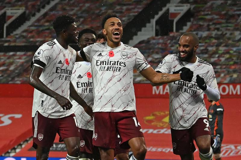 Arsenal striker Pierre-Emerick Aubameyang, centre, celebrates with teammates after scoring the winner from the penalty spot. AFP
