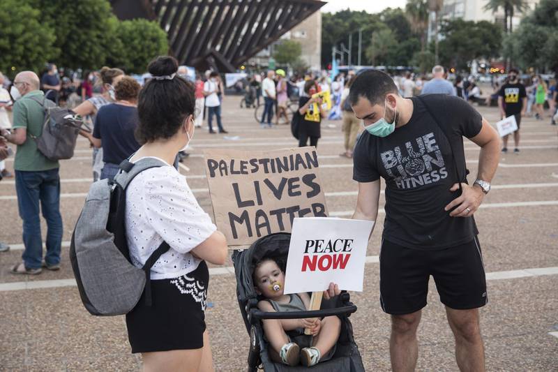 Israelis hold signs as they protest against Israel goverment's plan to annex parts of the West Bank in Tel Aviv, Israel. 
 Getty Images