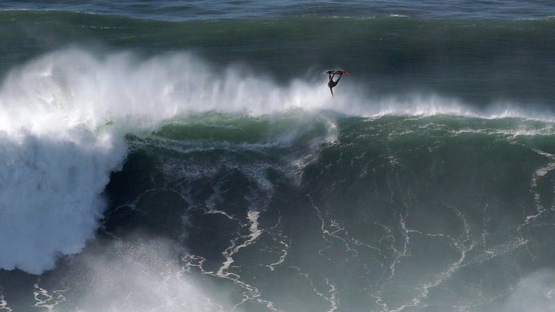 A surfer vaults over a wave  at Praia do Norte in Nazare, Portugal, Thursday, October 29. AP