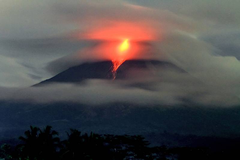 Lava spews out of Mount Merapi, Indonesia's most active volcano, during an eruption seen from Jrakah village, in Magelang on March 31, 2023.  (Photo by DEVI RAHMAN  /  AFP)