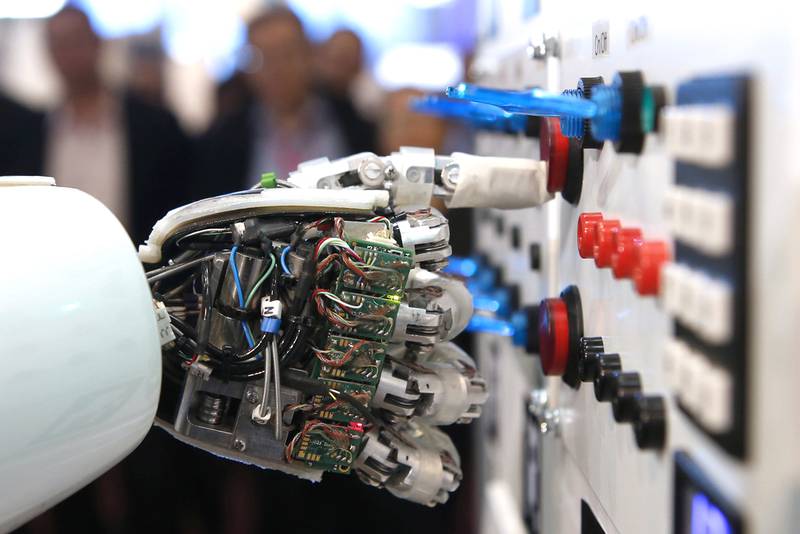 The hand of humanoid robot AILA (artificial intelligence lightweight android) operates a switchboard. Reuters
