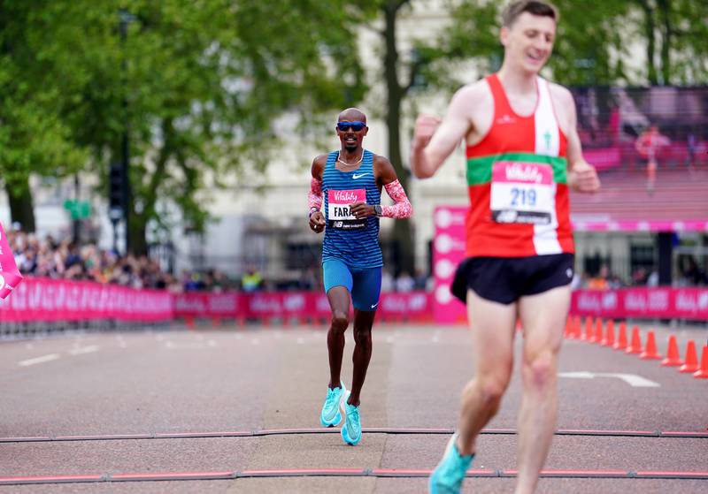 Mo Farah crosses the line to finish in second place in the men's race during the Vitality London 10,000. PA