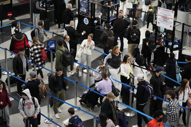 Travellers wait to go through a security checkpoint at O'Hare International Airport in Chicago, Illinois. AP