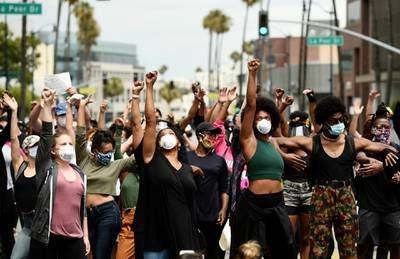 Protesters raise their fists during a rally in support of Black Lives Matter outside the Academy of Motion Picture Arts & Sciences in Beverly Hills, California. AP Photo.