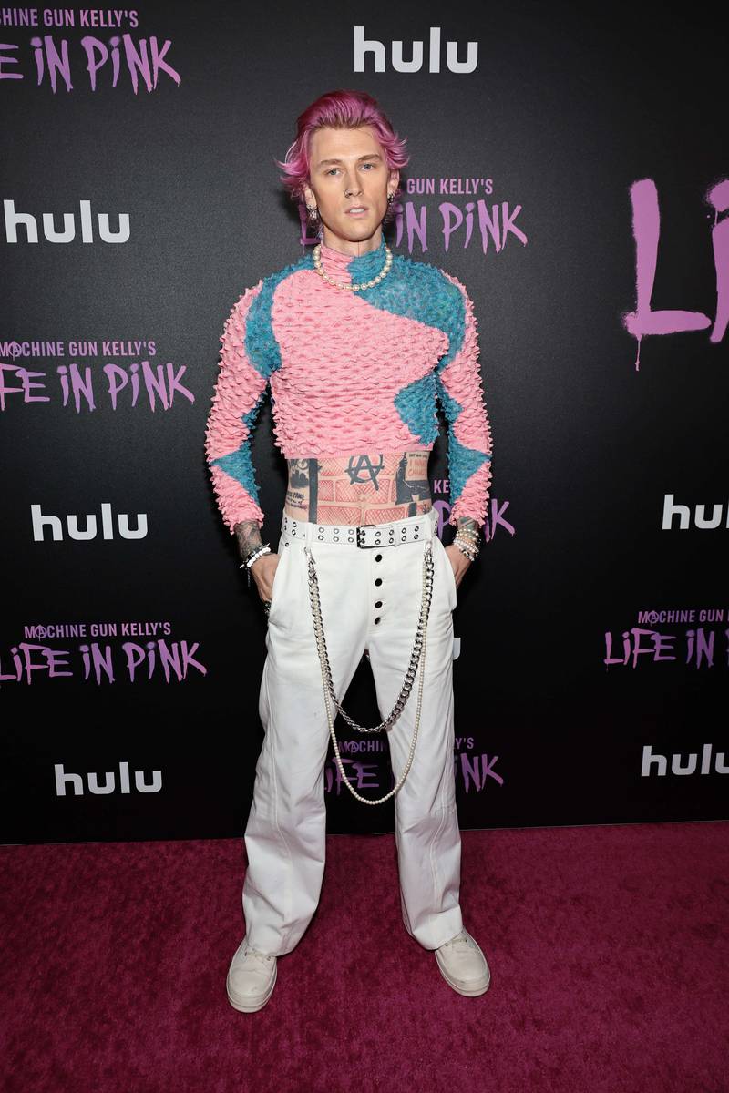 Musician Machine Gun Kelly with pink hair and a pink jumper at the premiere of the film 'Machine Gun Kelly's Life In Pink' in June. Getty 
