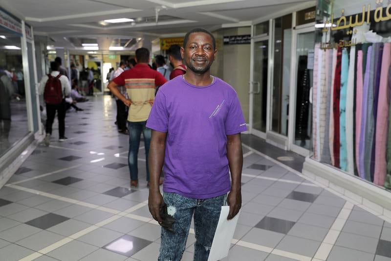 Kwaku Danso, from Ghana, queues to apply to become an RTA taxi driver.