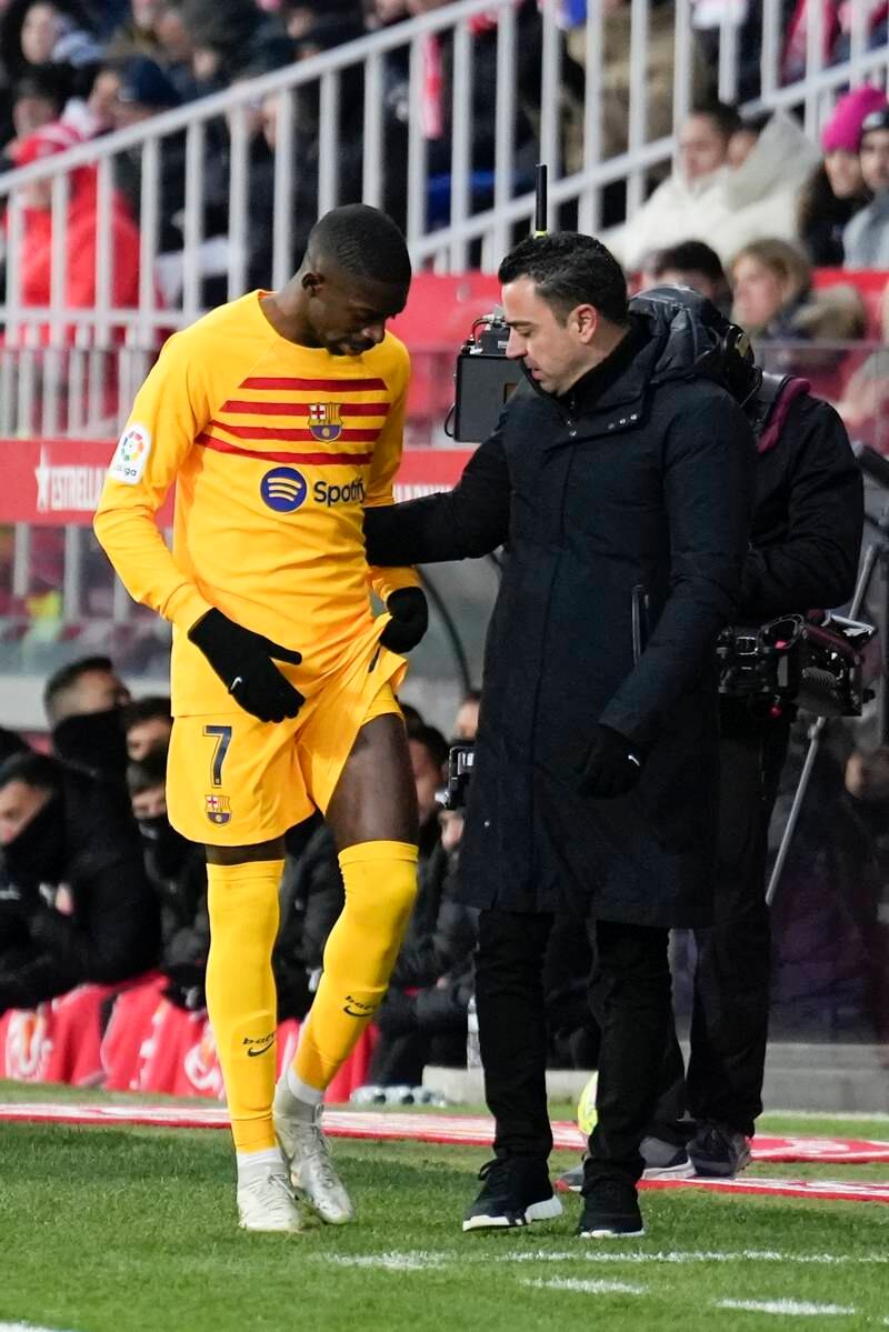 Barca's Ousmane Dembele talks with coach Xaci after suffering an injury. EPA