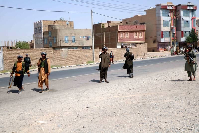 Supporters of former mujahideen commander Ismail Khan stand guard at a checkpoint in the Pul-e Malan area of Guzara district, in Herat, Afghanistan, on July 30, 2021.