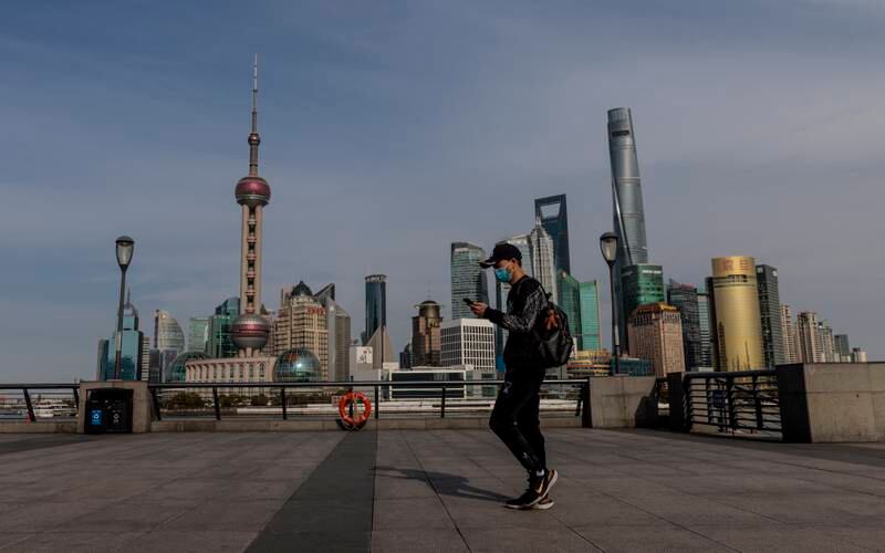 A man walks on the  Bound with Pudong main financial district in background, in Shanghai. EPA