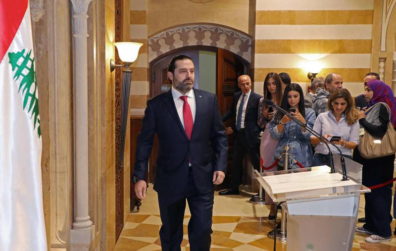 Mr Hariri walks to the podium to announce the resignation of his government. AFP