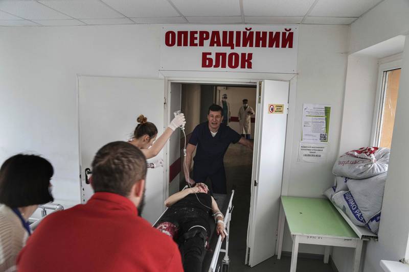 Oleksandr Konovalov, an ambulance paramedic, attends to an injured woman. AP Photo