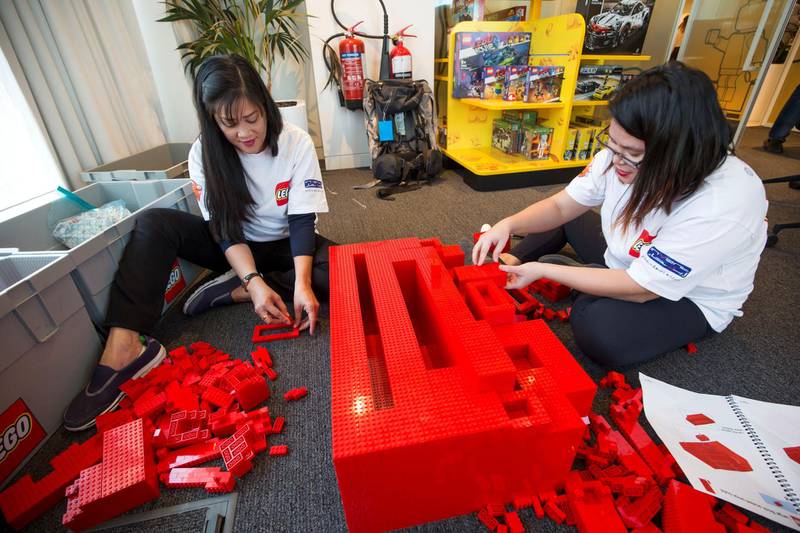 DUBAI, UNITED ARAB EMIRATES - Lego staff member building blocks at the opening of the new Lego office in Dubai Design District.  Leslie Pableo for The National