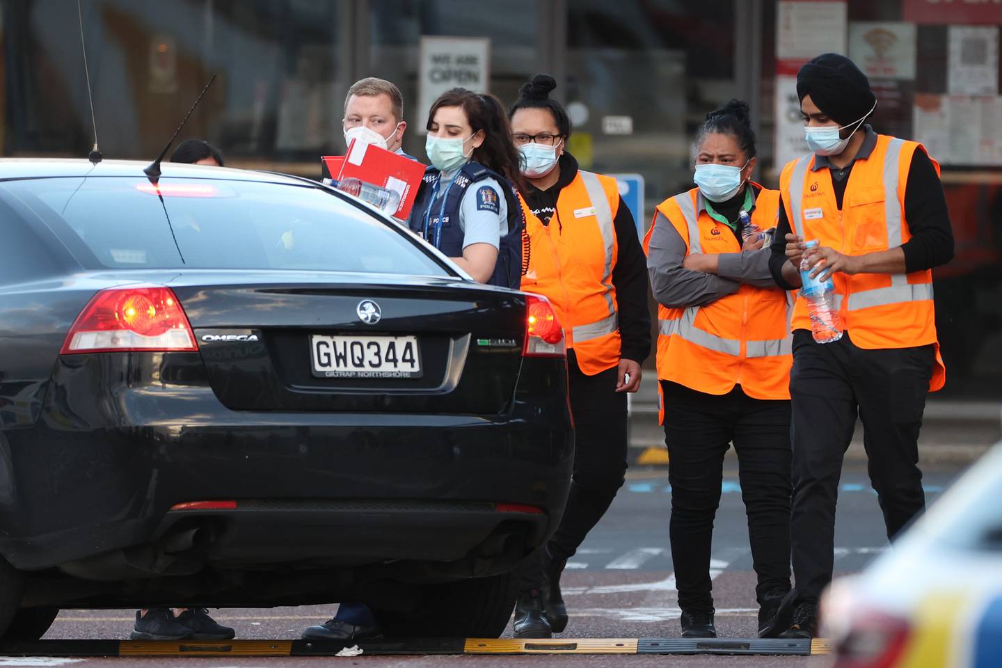 Employees of the Countdown mall in New Lynn, Auckland, wait to leave with police after a stabbing attack on September 3, 2021. Getty Images