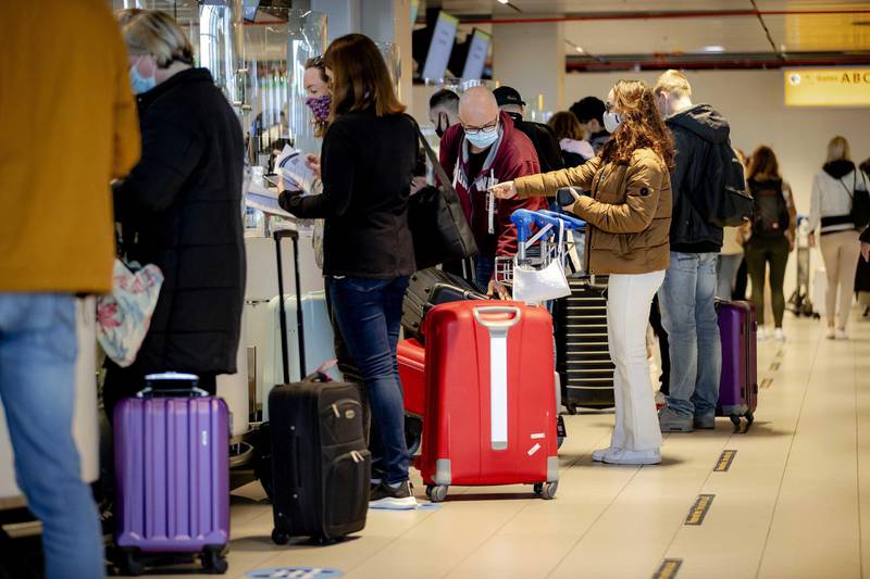 Travellers check-in at Schiphol in Amsterdam, the Netherlands. 189 holidaymakers left from the airport for a test holiday, with the aim of establishing whether a test protocol makes it possible to travel during the pandemic. EPA